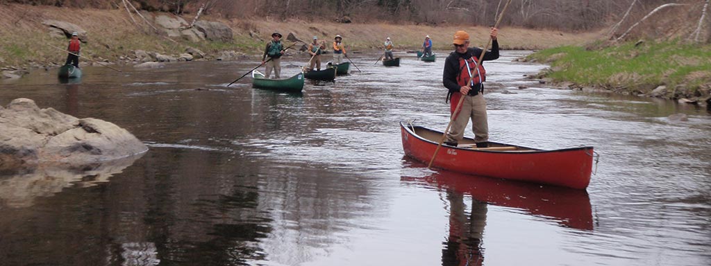 Smoking Rivers expert guide instructing clients on proper canoe handling